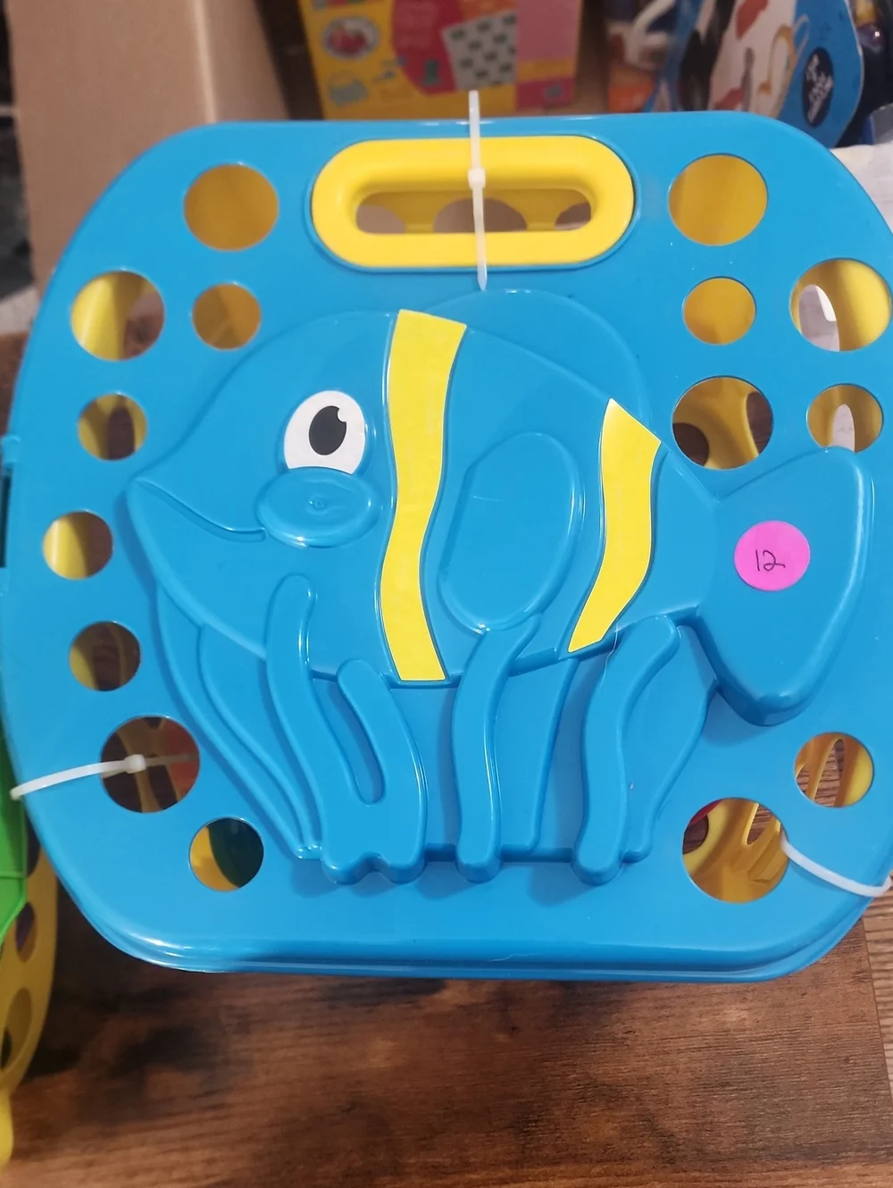 Green Frog Shape Box With Sand Casle Stuff For The Beach In It. And A Blue Fish